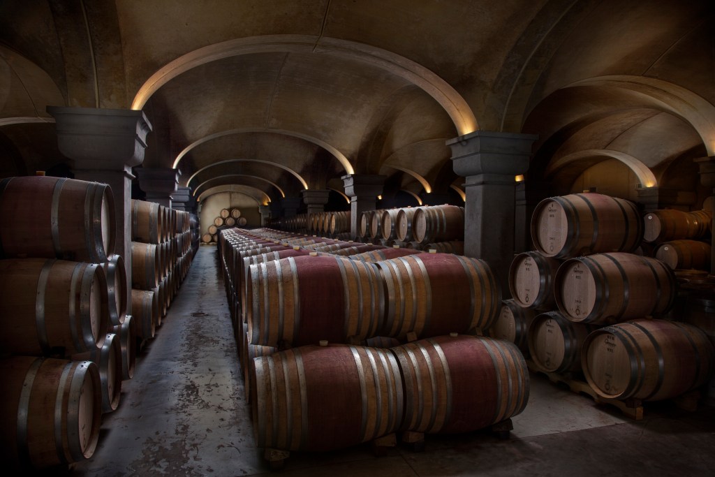 This is an image of wine barrels in an aging cave