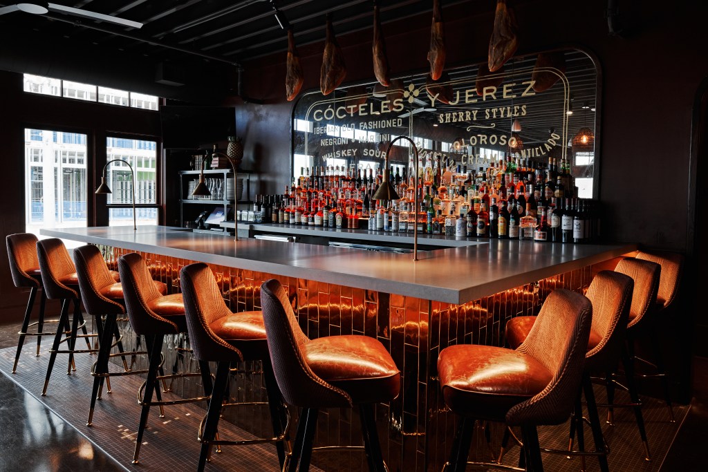 The bar at the Iberian Pig in Nashville features leather and corduroy chairs and mirrored tiles