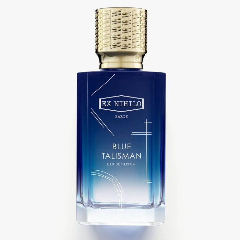 A bottle of Ex Nihilo's Blue Talisman eau de parfum. Blue glass with white lines on it and a gold cap