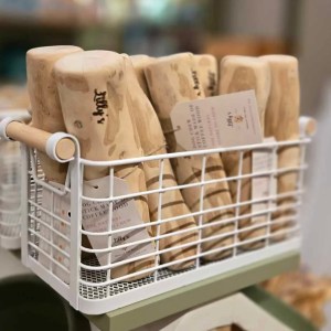 Several coffee wood dog chews in a basket