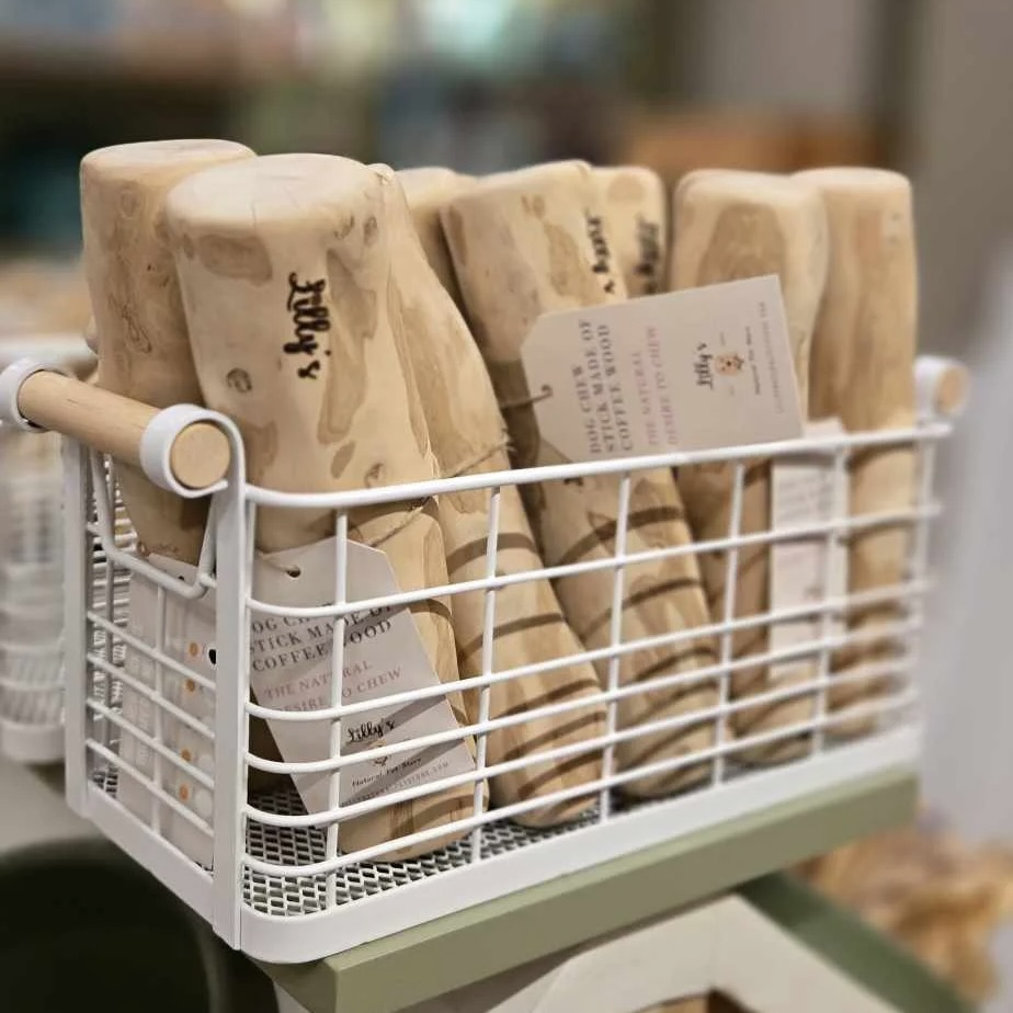 Several coffee wood dog chews in a basket