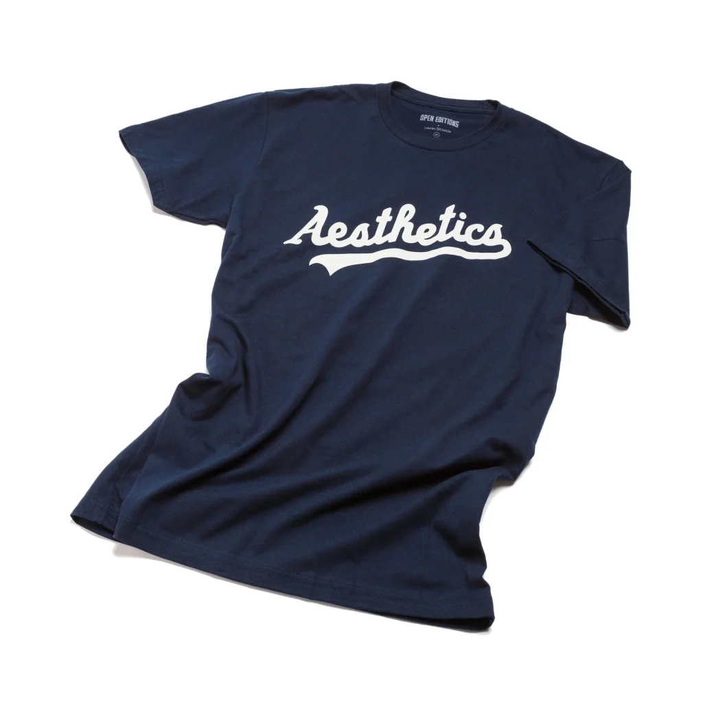 A navy blue crewneck t-shirt with the word "Aesthetics" written on it in athletic team style