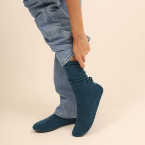 A pair of knit shoes looks like socks but has a firm sole