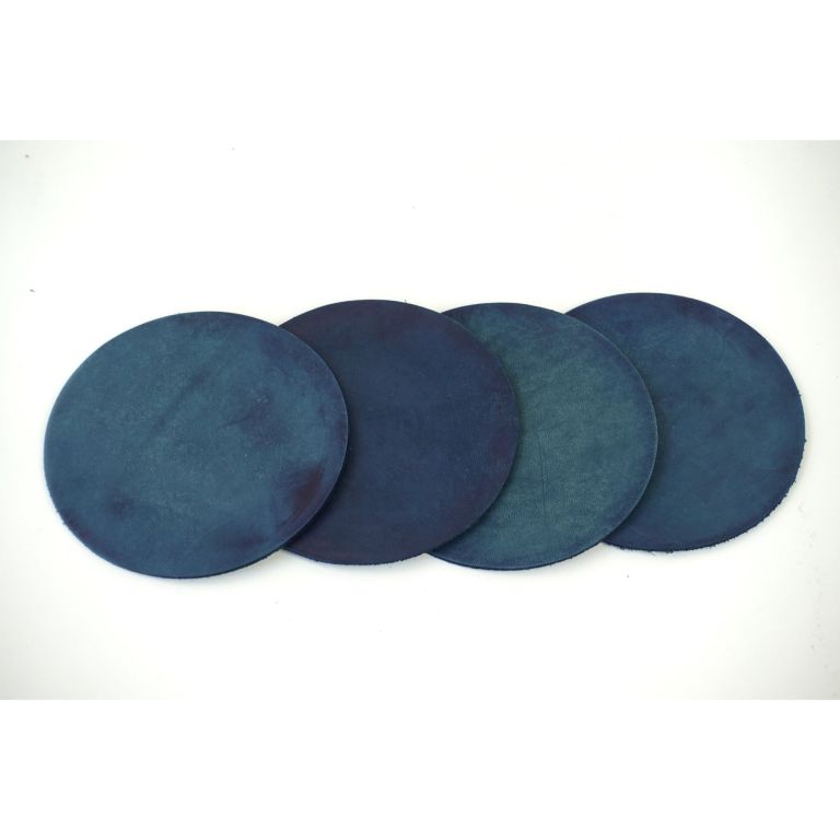 Four natural indigo dyed round leather coasters