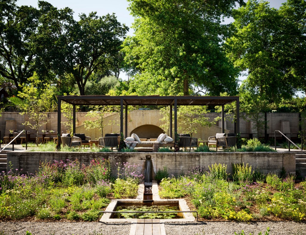outdoor garden with seating under a trellis