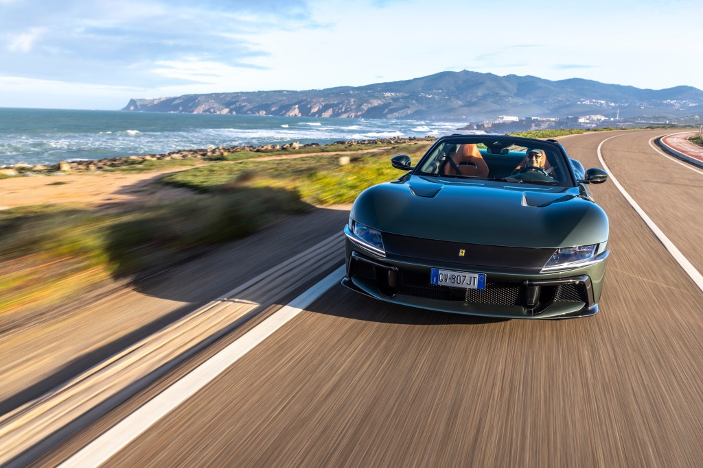 front view of car in motion with smiling driver