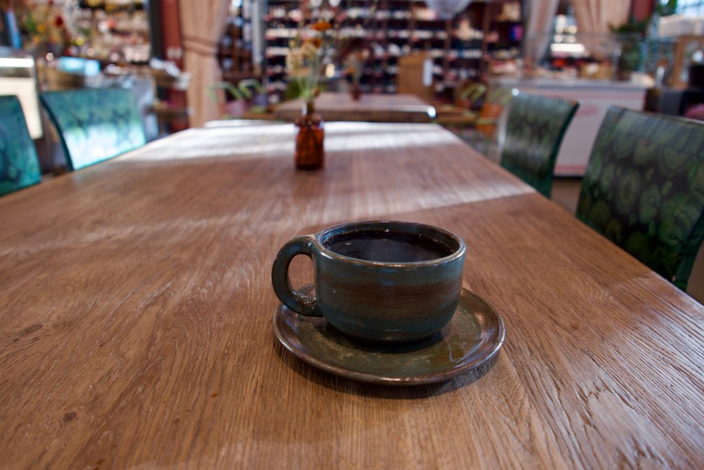 handmade ceramic cup of coffee on a wood table