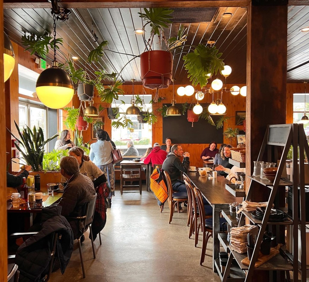 interior of cafe with plants and people