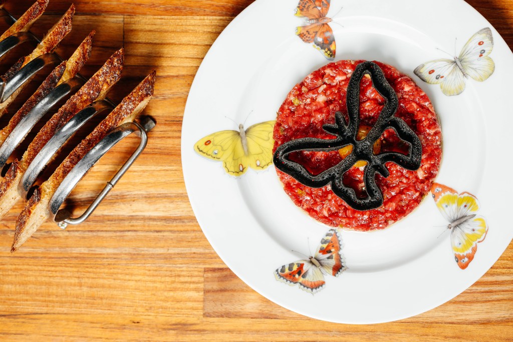 butterfly shaped cracker on top of red tart