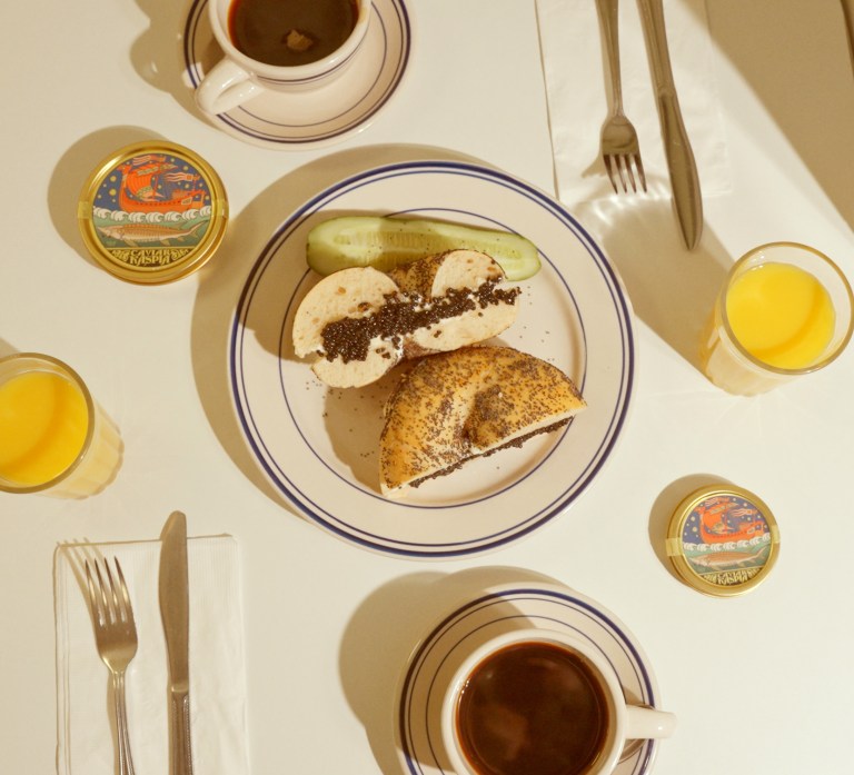 bagel with cream cheese and caviar on a plate