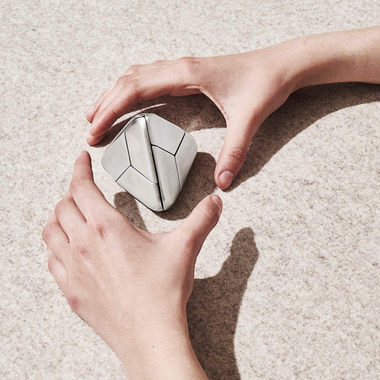 The Tetra Puzzle by Craighill fits in your hand, is made from stainless steel, and looks like a triangle