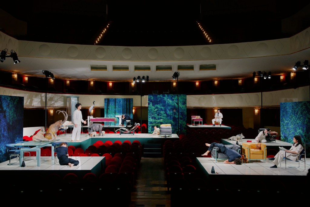 Cassina's "Staging Modernity" installation shows various furniture, actors and props on plinths in a theatre
