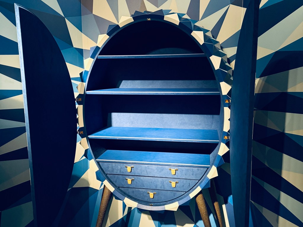 The inside of the oval cabinet is lined in blue leather