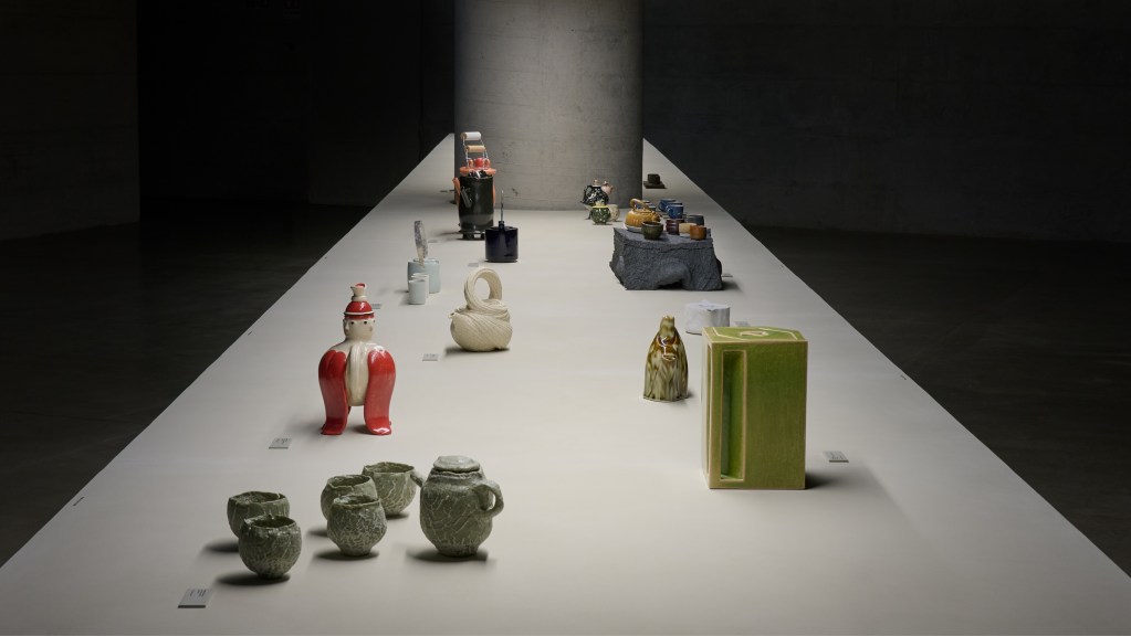Several of the tea pots in vairous forms and colors on display at the Loewe Teapot collection