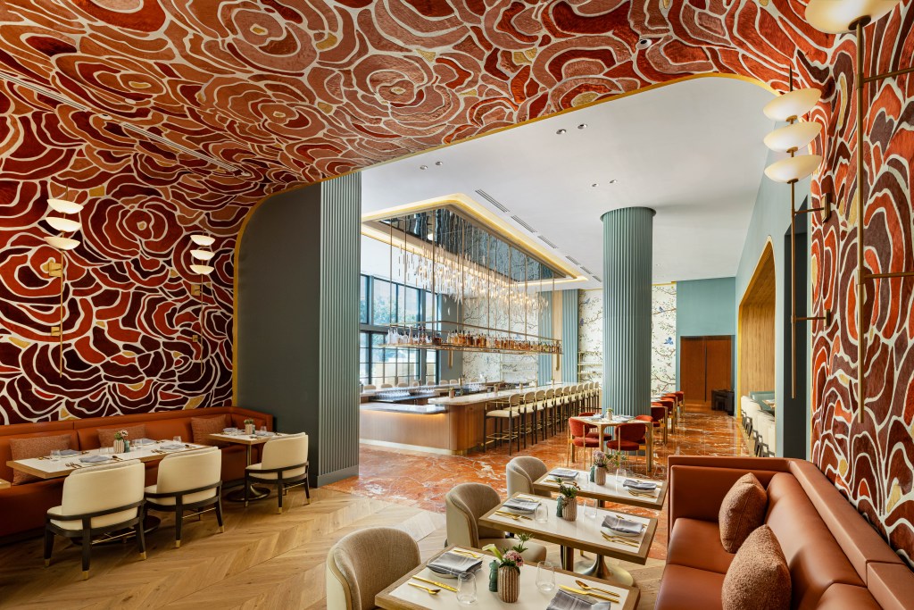 Inside of the W Austin's Seranade restaurant is a dramatic, colorful wall and ceiling covering of desert flowers made in cowhide