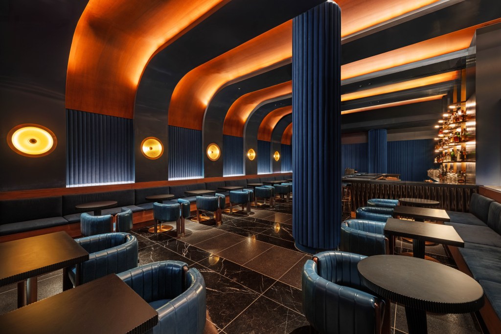 The W Austin's Blue Room features a dark blue interior and more dramatic lighting
