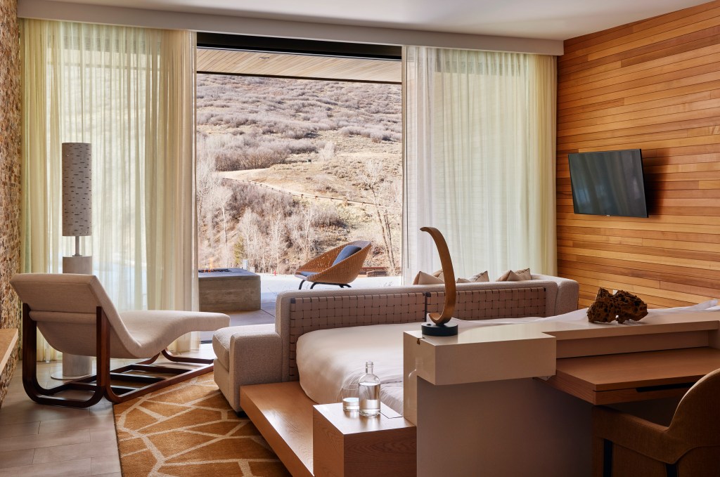 bedroom suite with wooden walls and mountain view
