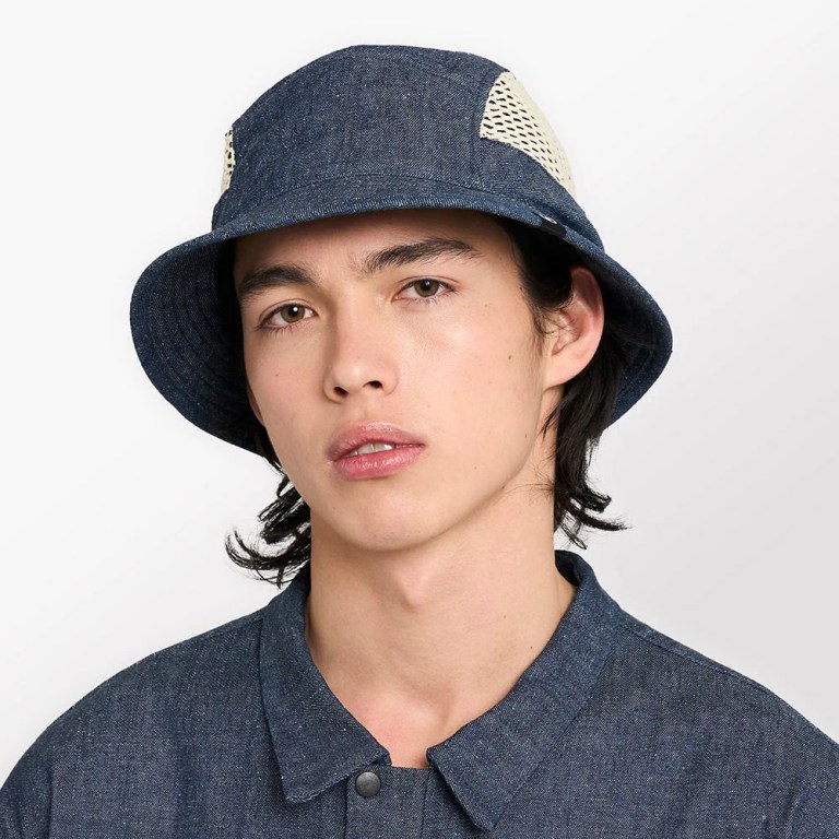 Ciele Athletics' denim and mesh running hat is worn by a male model