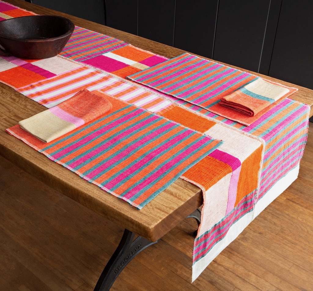 A wood dining table with the Bolé Road collection of items inspired by The Metropolitan Museum of Art's African collection