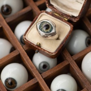 A box of vintage prosthetic eyes and a ring