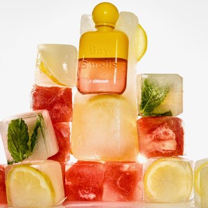 A bottle of Boy Smells Citrush is nested into iced fruit cubes