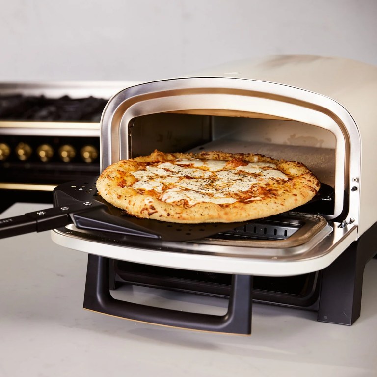 Current's Pizza Over sits on a kitchen counter with it's door open and a cooked pizza inside