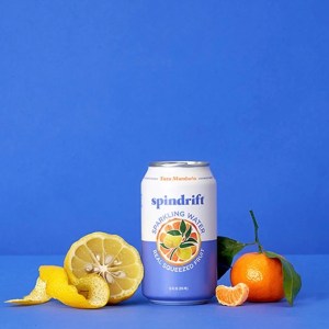 A can of SPindrift's Yuzu Mandarin sparkling water alongside a peeled yuzu and a mandarin