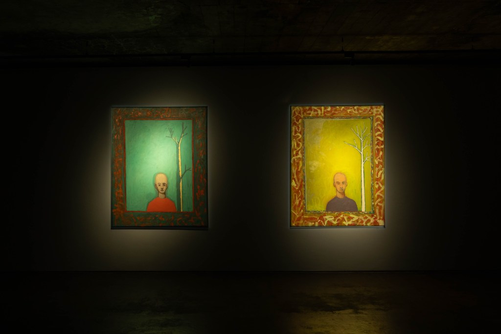 Two Alexander Graf von Schlieffen paintings hanging in a dark gallery room