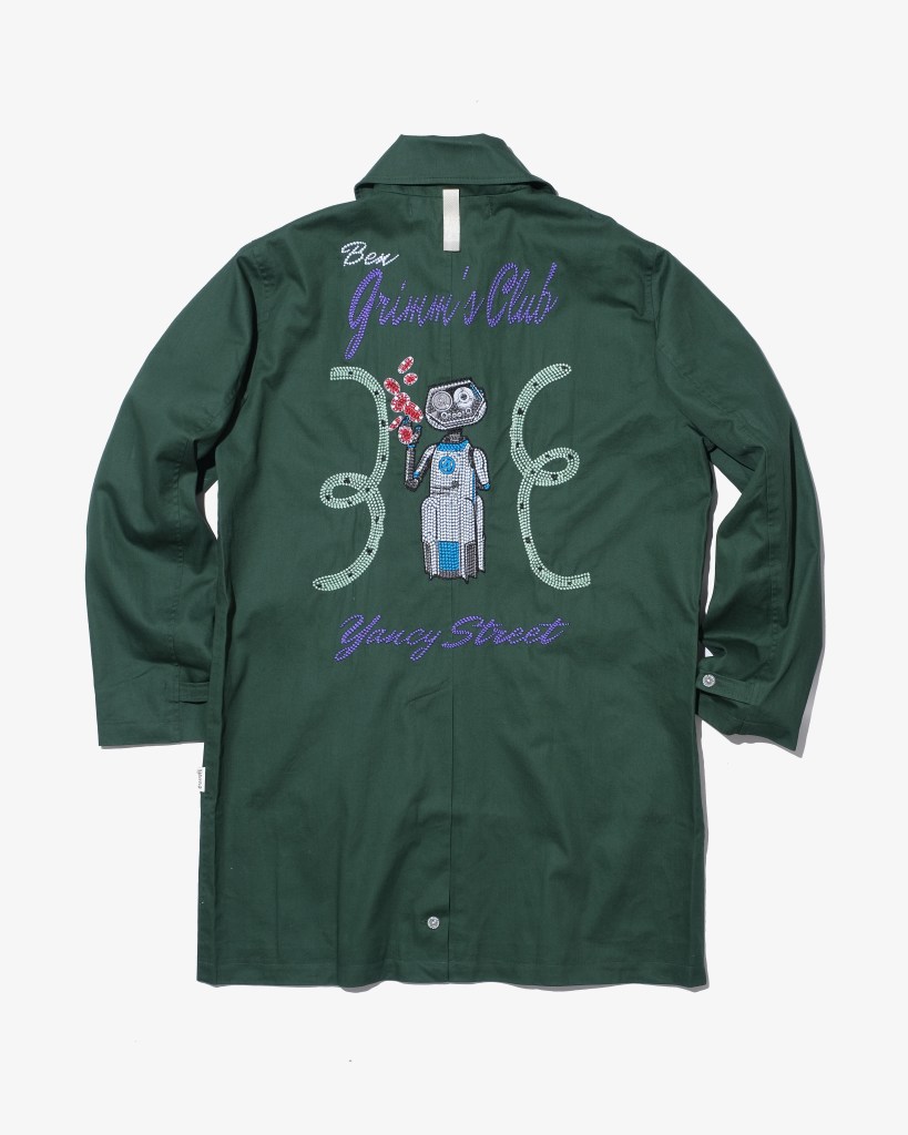 A green Advisory Board Crystals jacket with embroidery on the back.