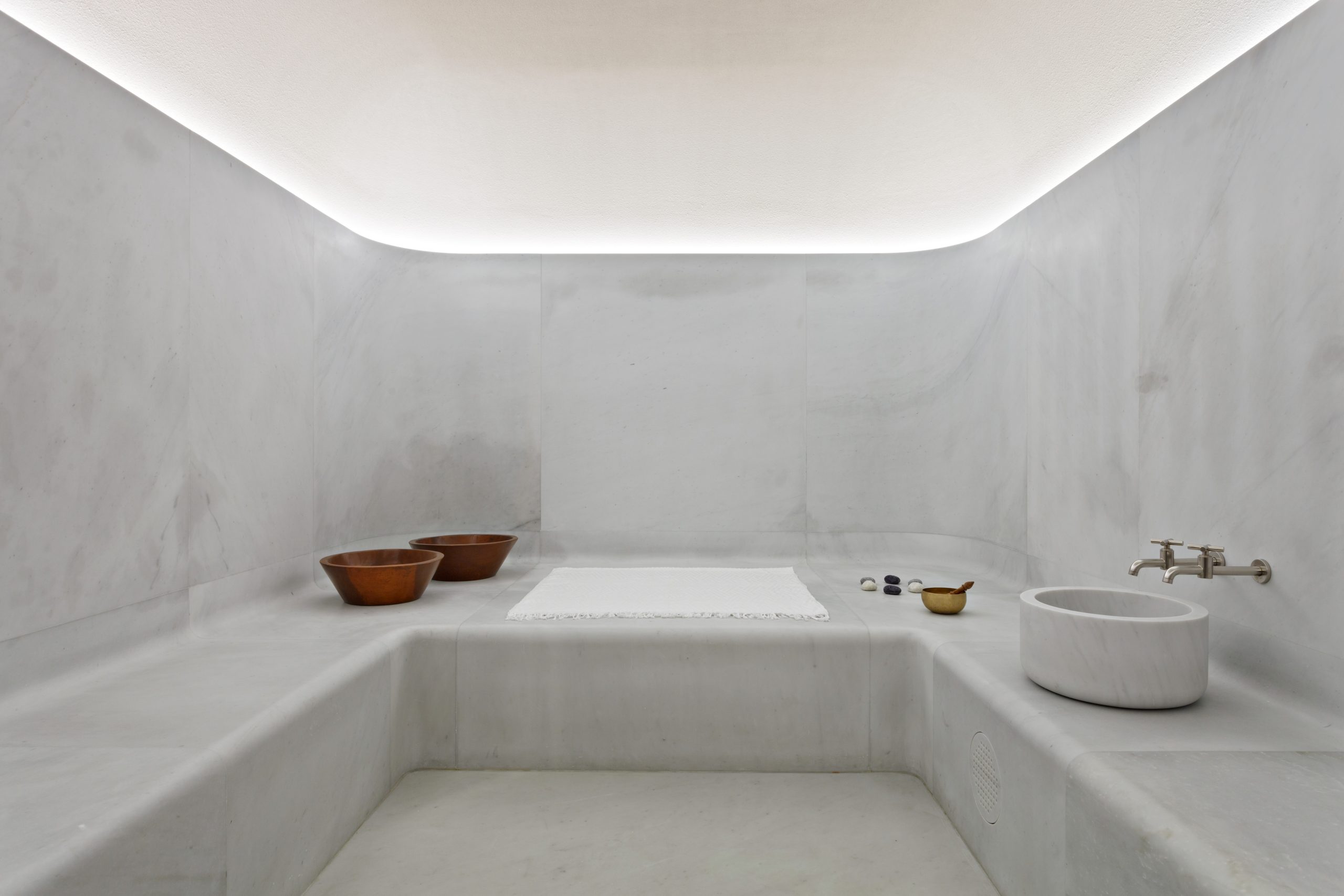A white marbled hammam steam room.