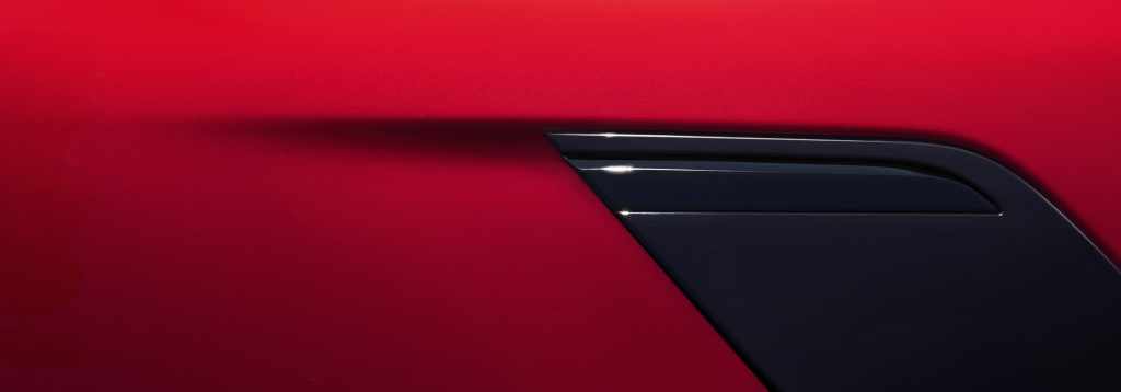 A detail of a red Range Rover Sport.
