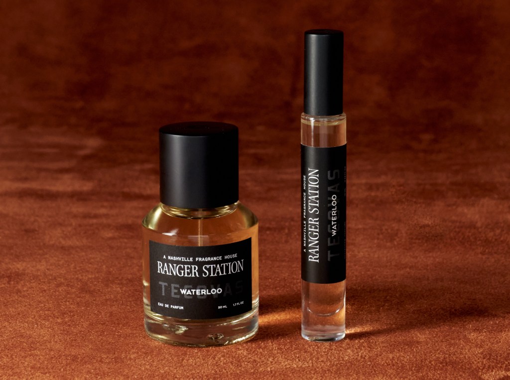 small and medium glass perfume bottles on a brown suede background