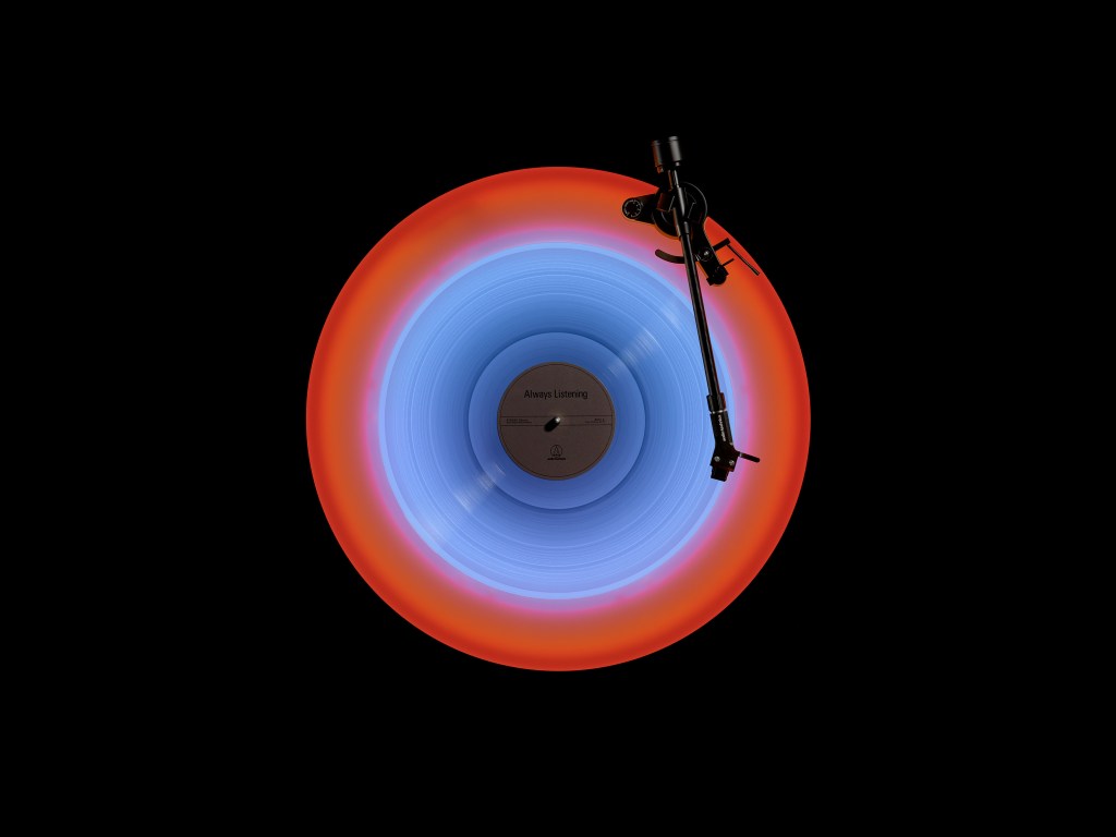 A turntable shot from above, glowing red and blue. 