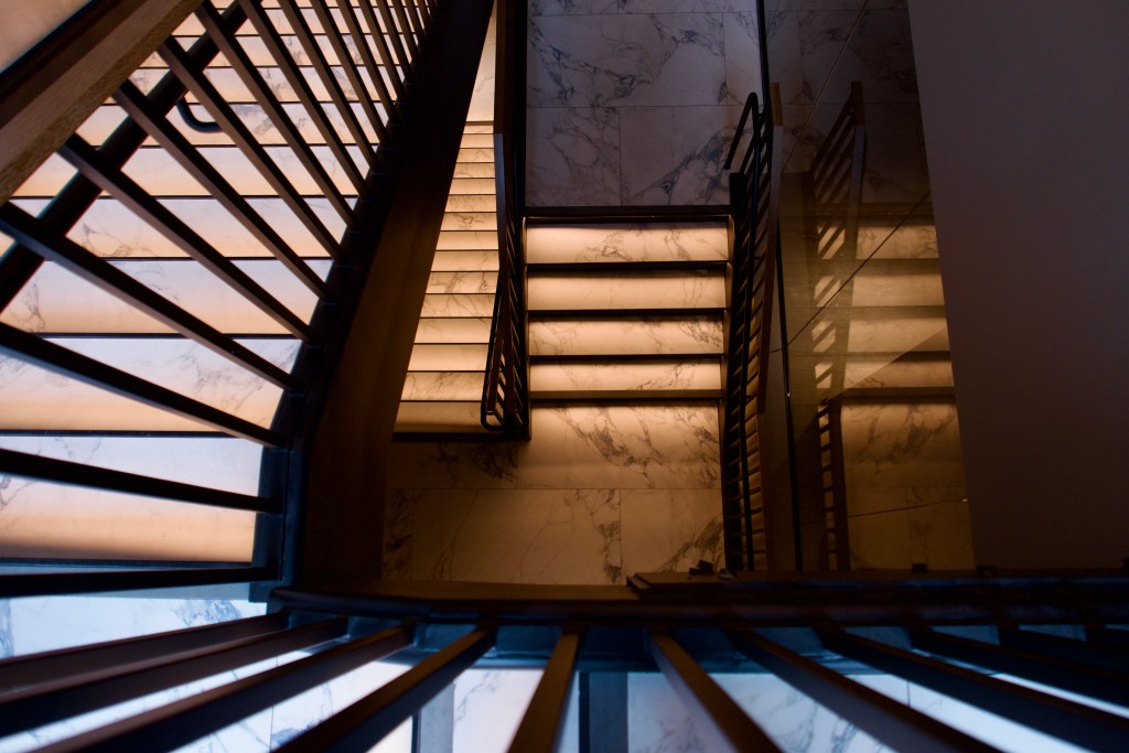 A spiral staircase shot from above.