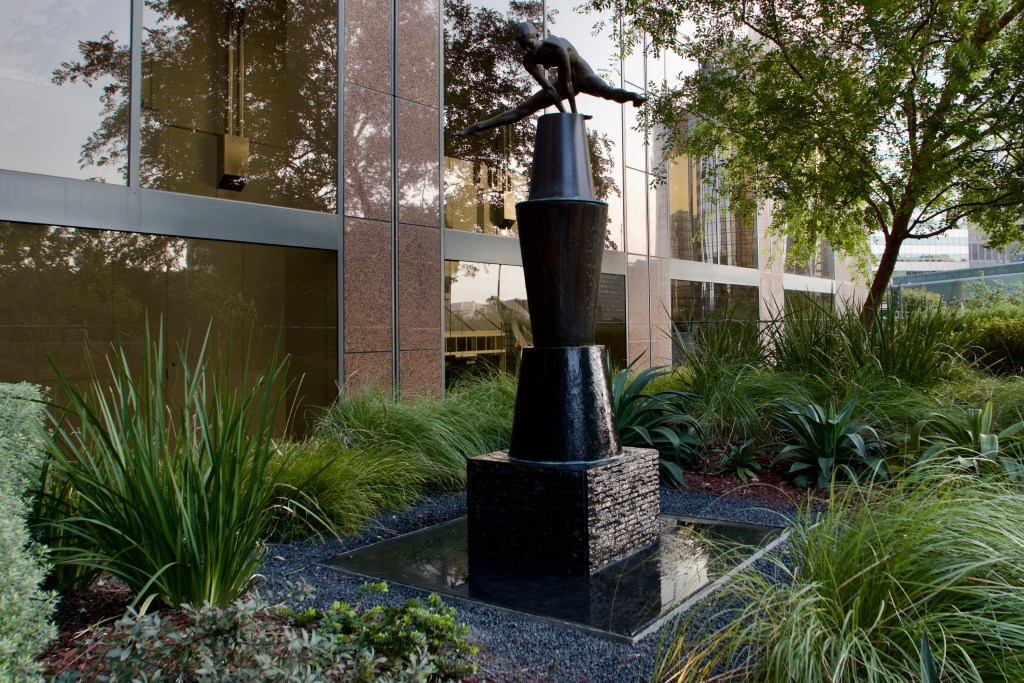 A sculpture in a building's garden space.