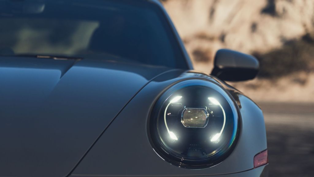 A detail of a Porsche 911 Carrera's headlight.