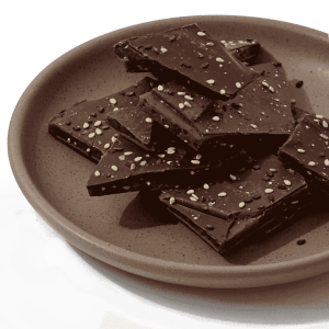 Pieces of Dandelion Chocolates black sesame toffee brittle made in collaboration with Neococoa, on a plate
