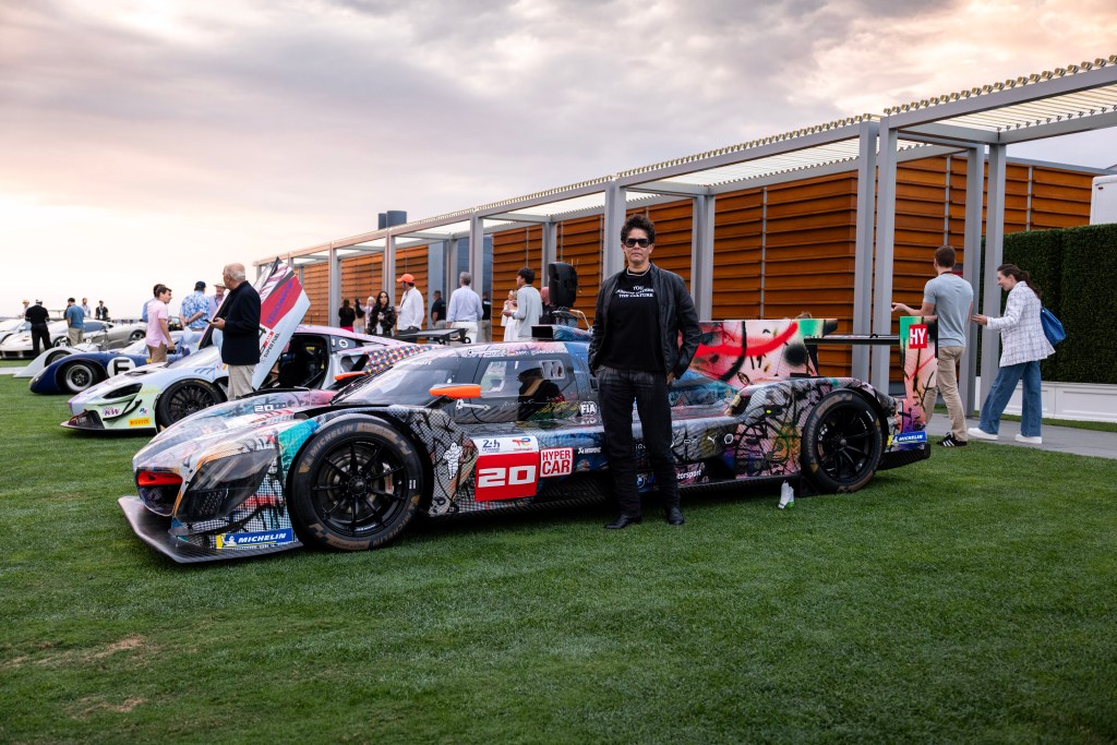 Artist Julie Mehretu, in front of BMW's 20th Art Car.