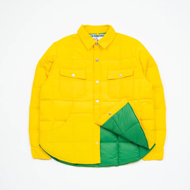 Big Rock Candy Mountaineering's Bidalveil jacket is shown in a bright yellow on a white background, with a corner of the front lifted up to show the bright green interior