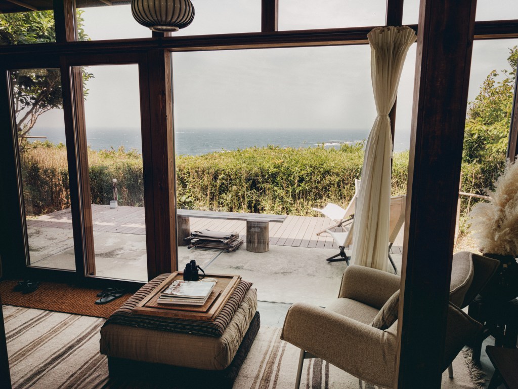 An interior view of DAMDAM Tokyo's founders home with views of the Pacific Ocean and Mt Fuji.