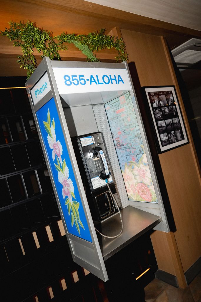A vintage 855-ALOHA phone booth at Romer House Waikiki.