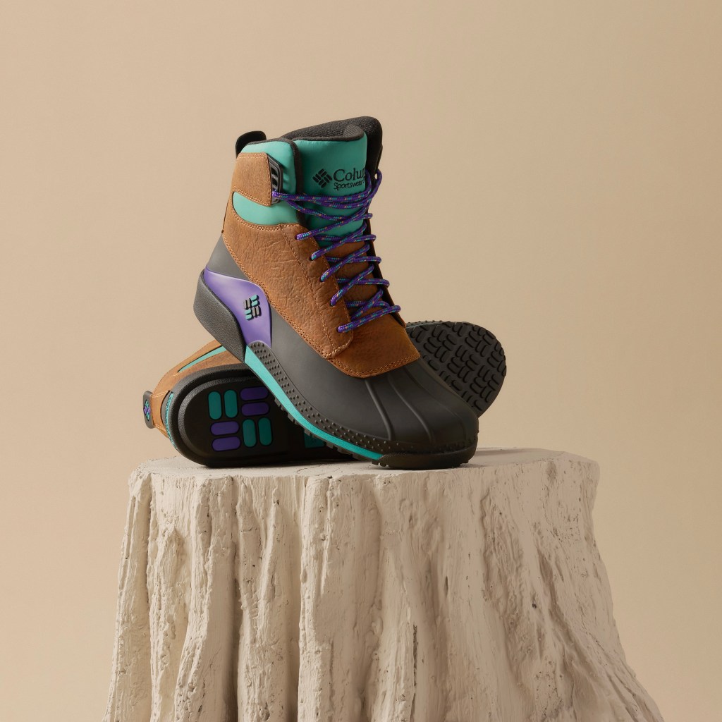 Columbia's re-edition of its iconic 1993 Bugaboot, it's first shoe, is shown in its original colorway of black, brown, purple and teal, fron the front at an angle