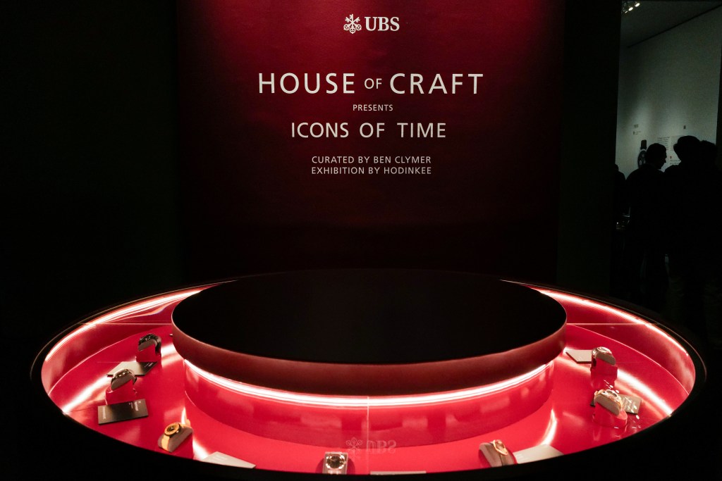 A red circular display showing 12 watches as part of the Icons of Time exhibition.