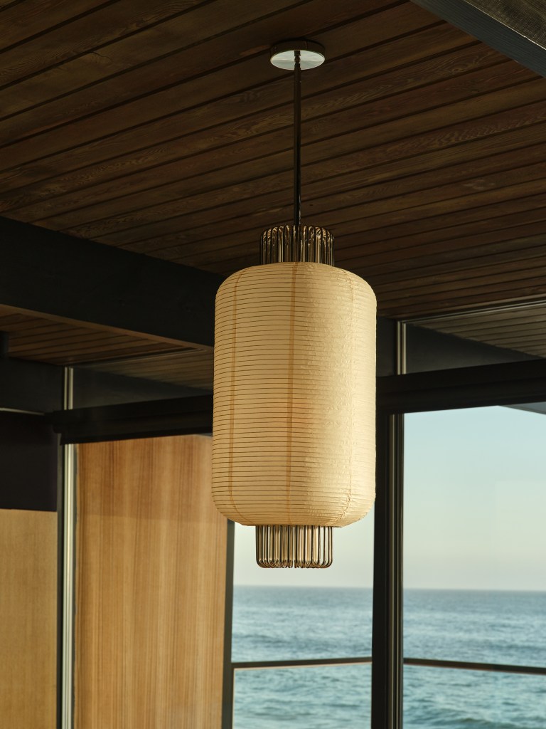 A Nagaro pendant light hanging from a wooden ceiling.