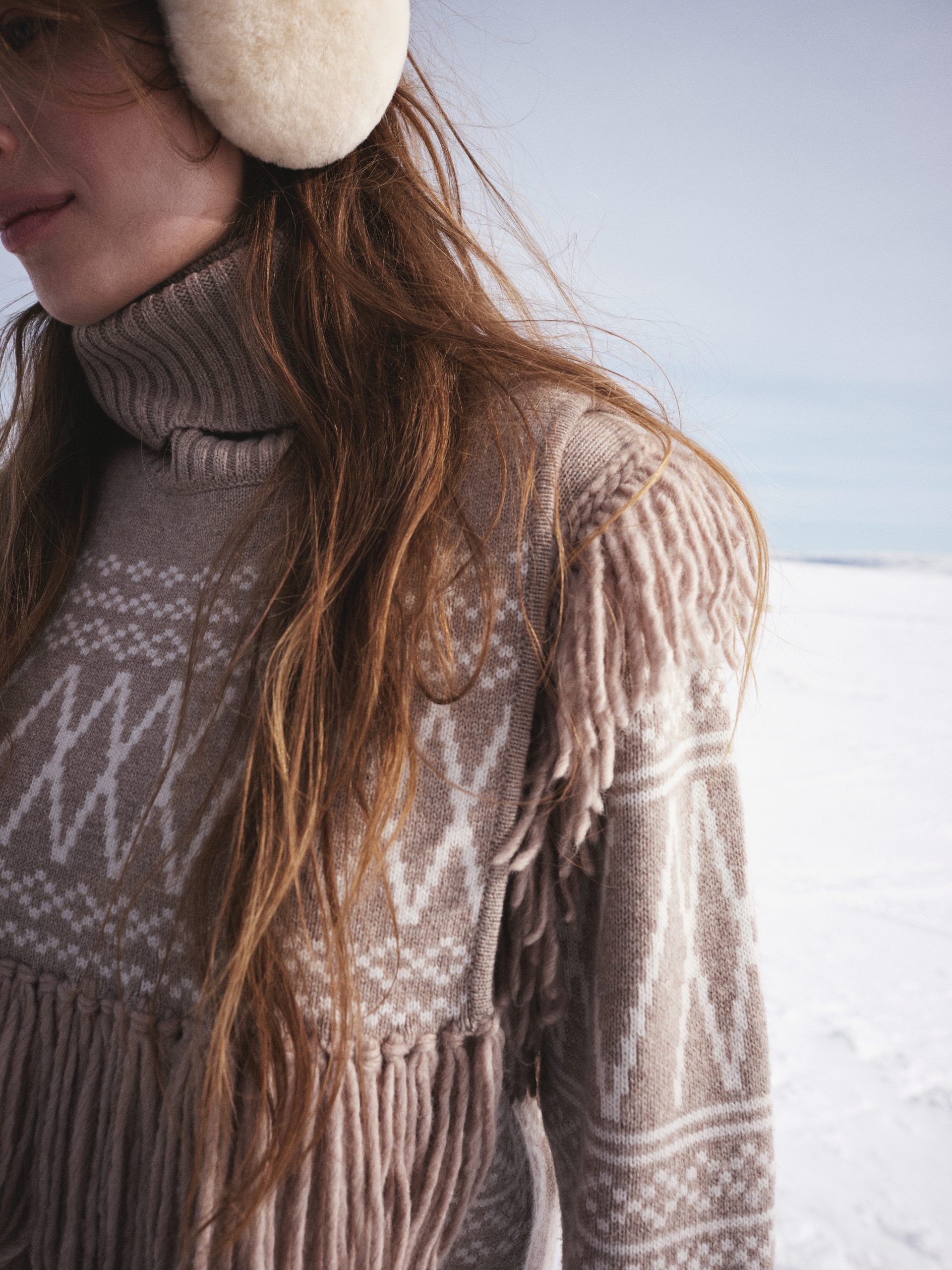 A detail of a fringed shoulder on a wool We Norwegians sweater.