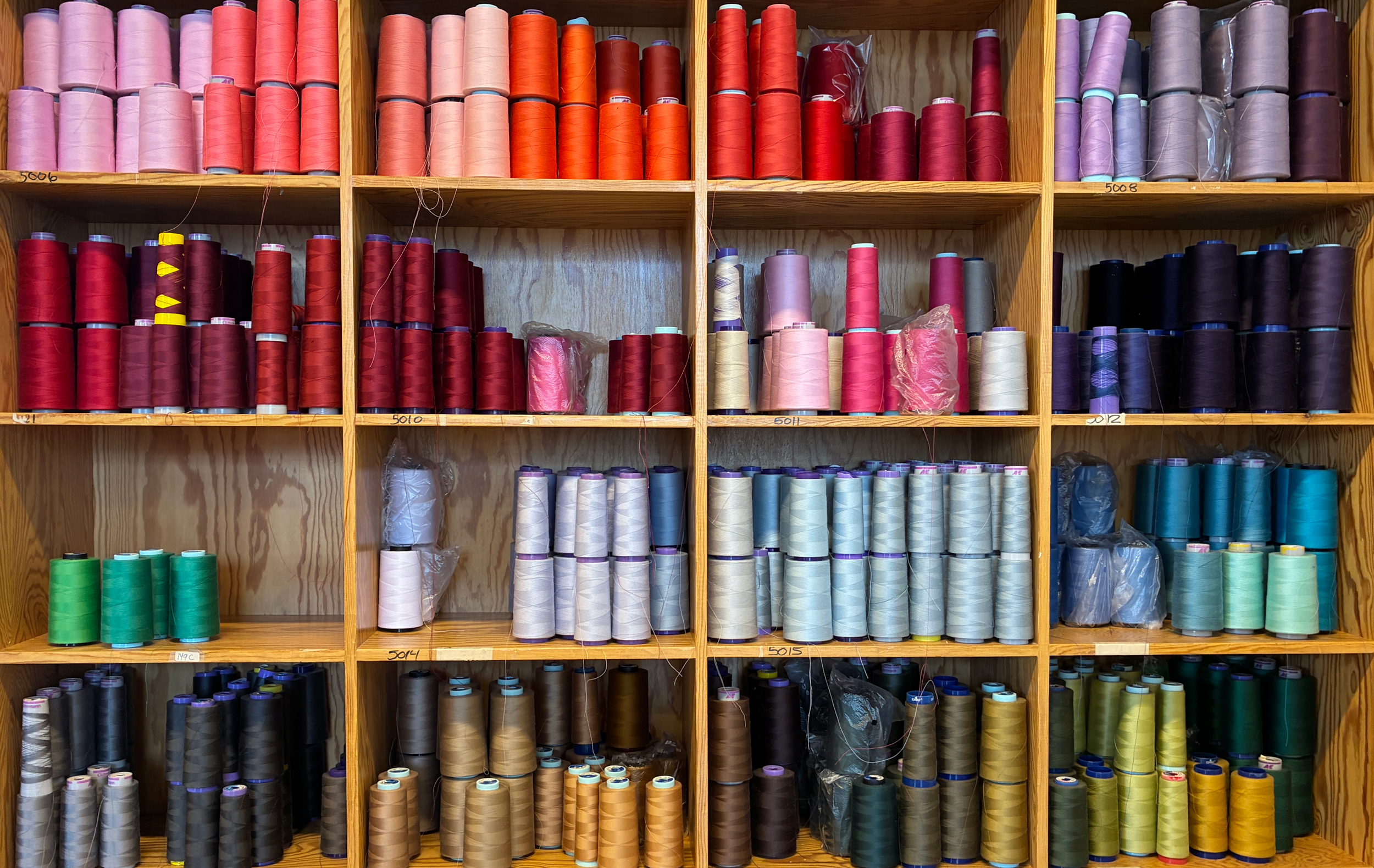 A detail of colorful yarns on a shelf at Oleana.