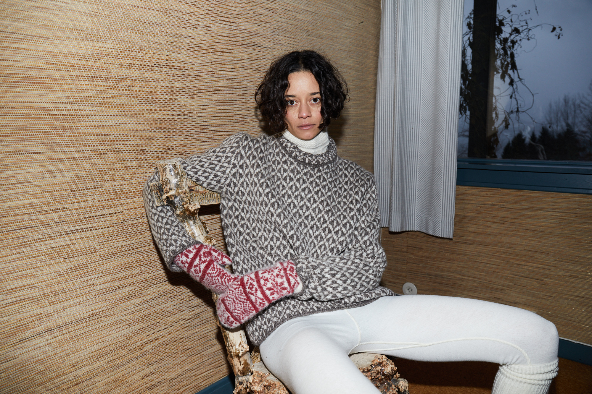 A model wearing an O.A.D. sweater and white leggings.