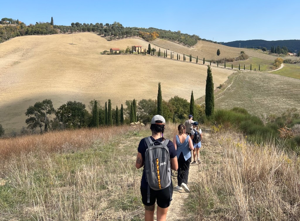 A group of travelers on a hiking tour of Tuscany.