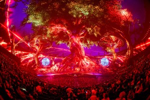 A photo of the Unity show at Sphere Las Vegas—with bright trees in deep colors, and the audience can be seen