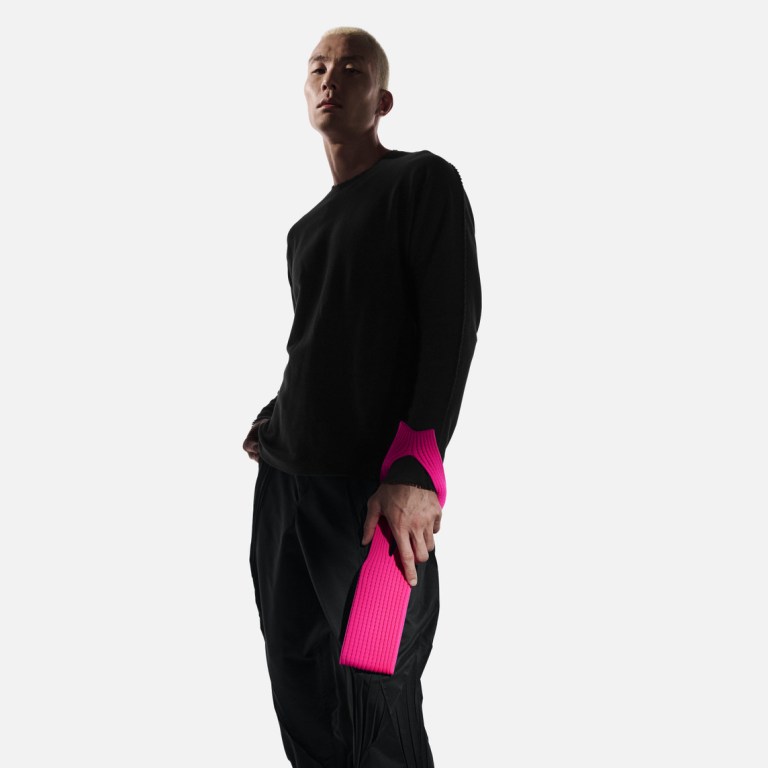 A man holds an Apple iPhone Pocket by ISSEY MIYAKE
